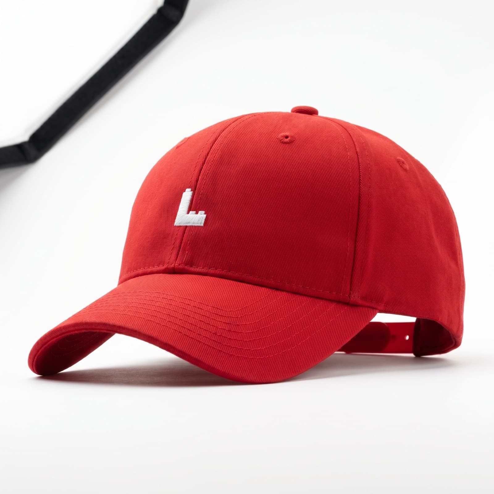 A red cap with a white embroidered 'L' mark on the front