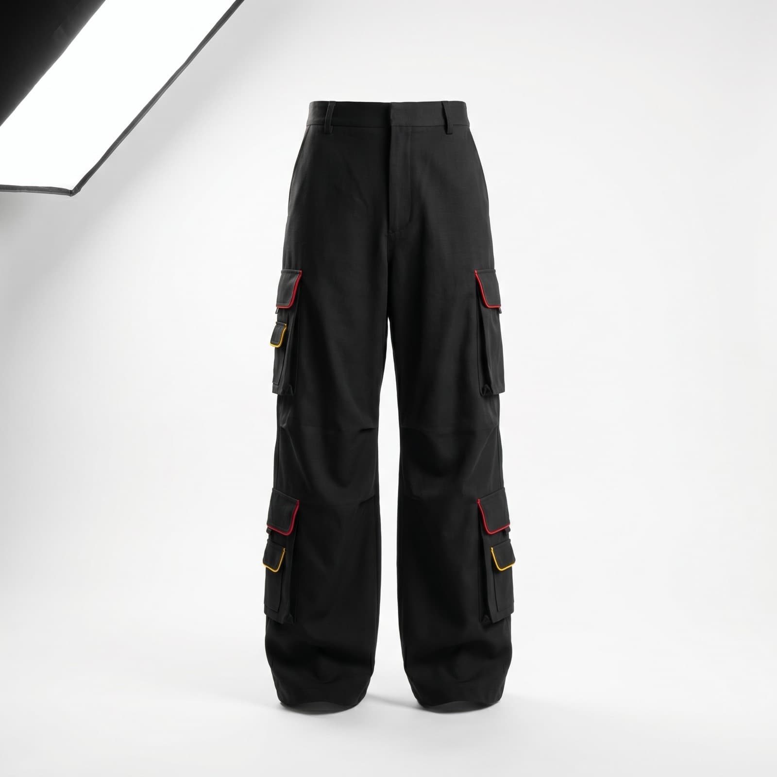 Black cargo pants with multiple pockets and red-and-yellow contrast piping