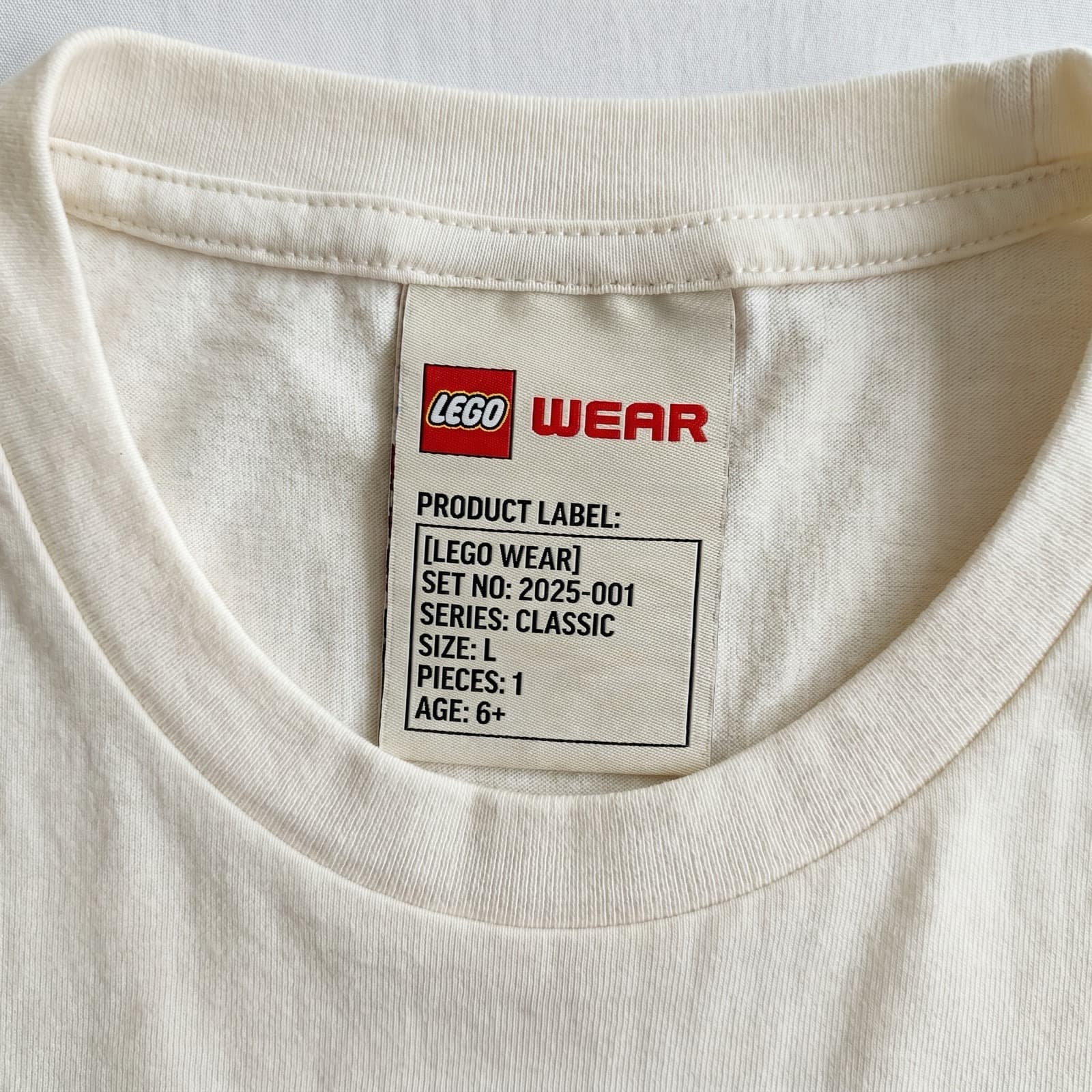 A close-up strip of the product label, stitching and hardware details