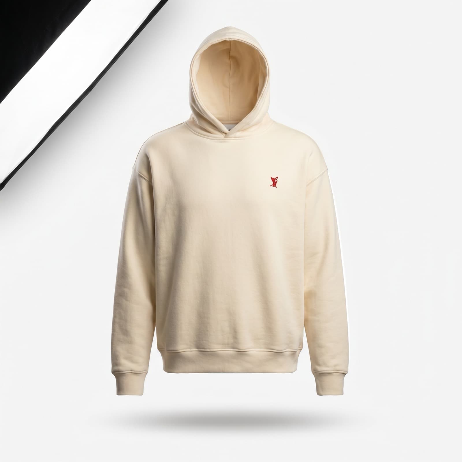 An oversized black sweatshirt with a small red brand mark on the chest